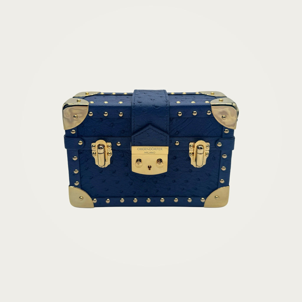 Ostrich Mini Trunk Handbag on an ivory studio ground