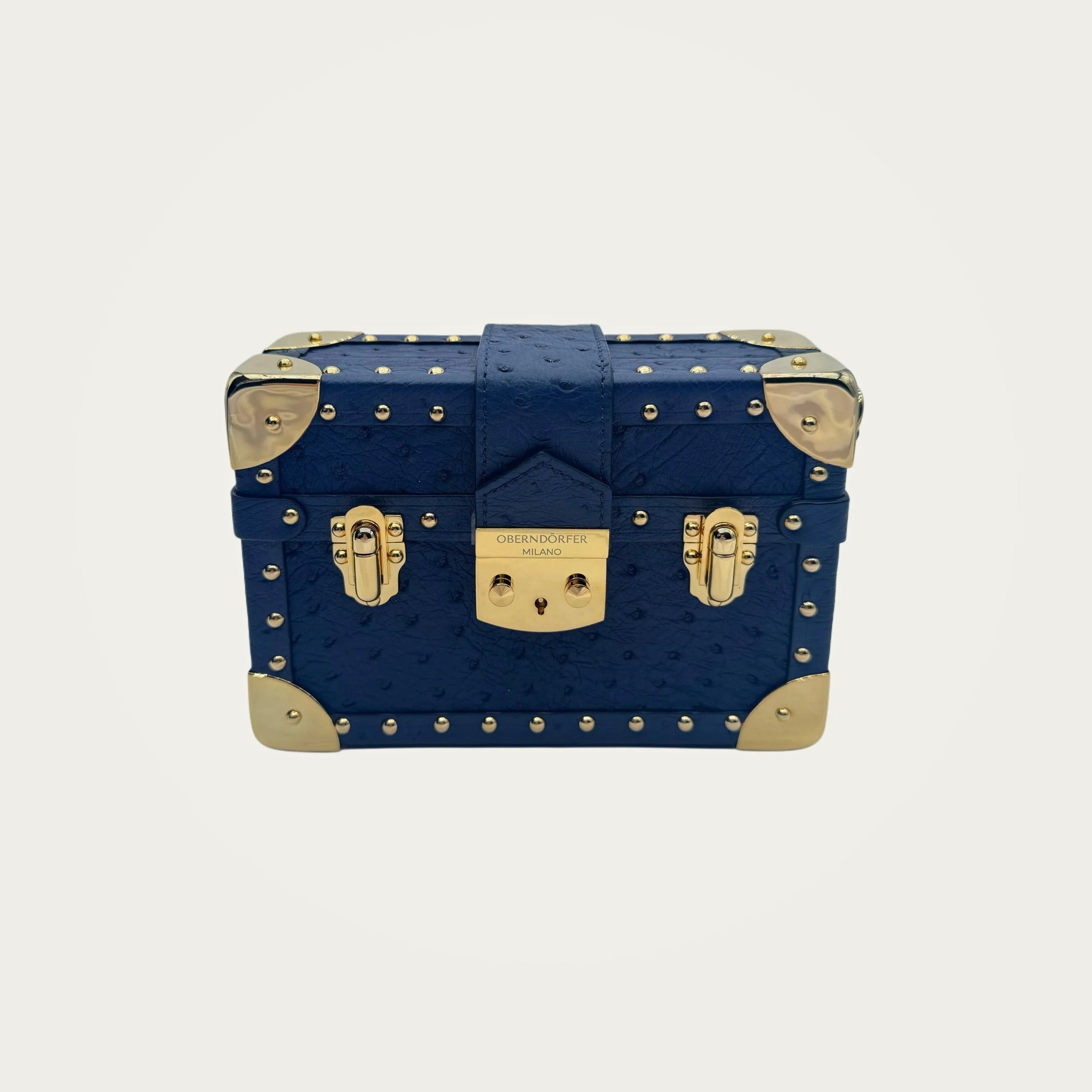 Ostrich Mini Trunk Handbag on an ivory studio ground