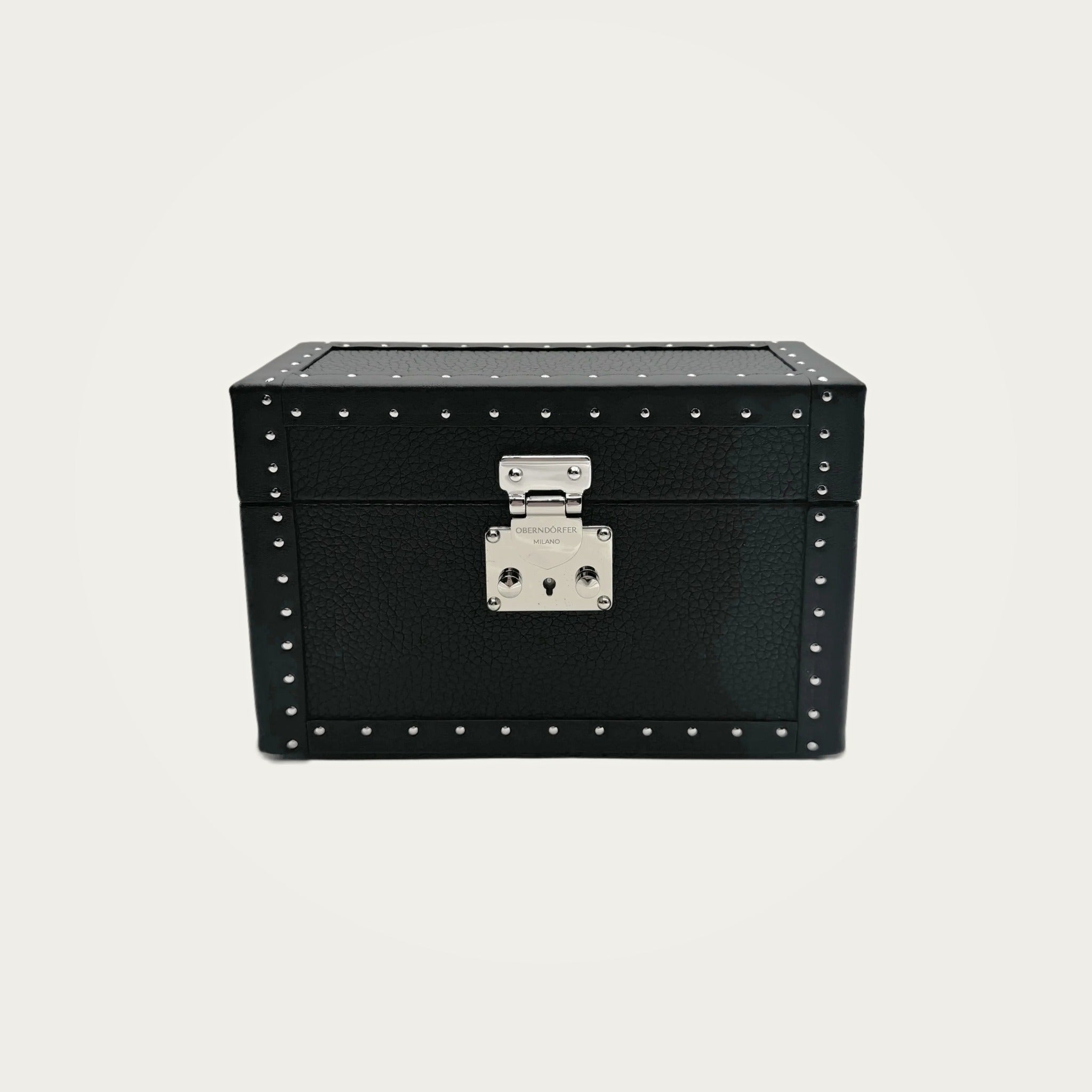 Vault Bag in black studded leather on an ivory studio ground