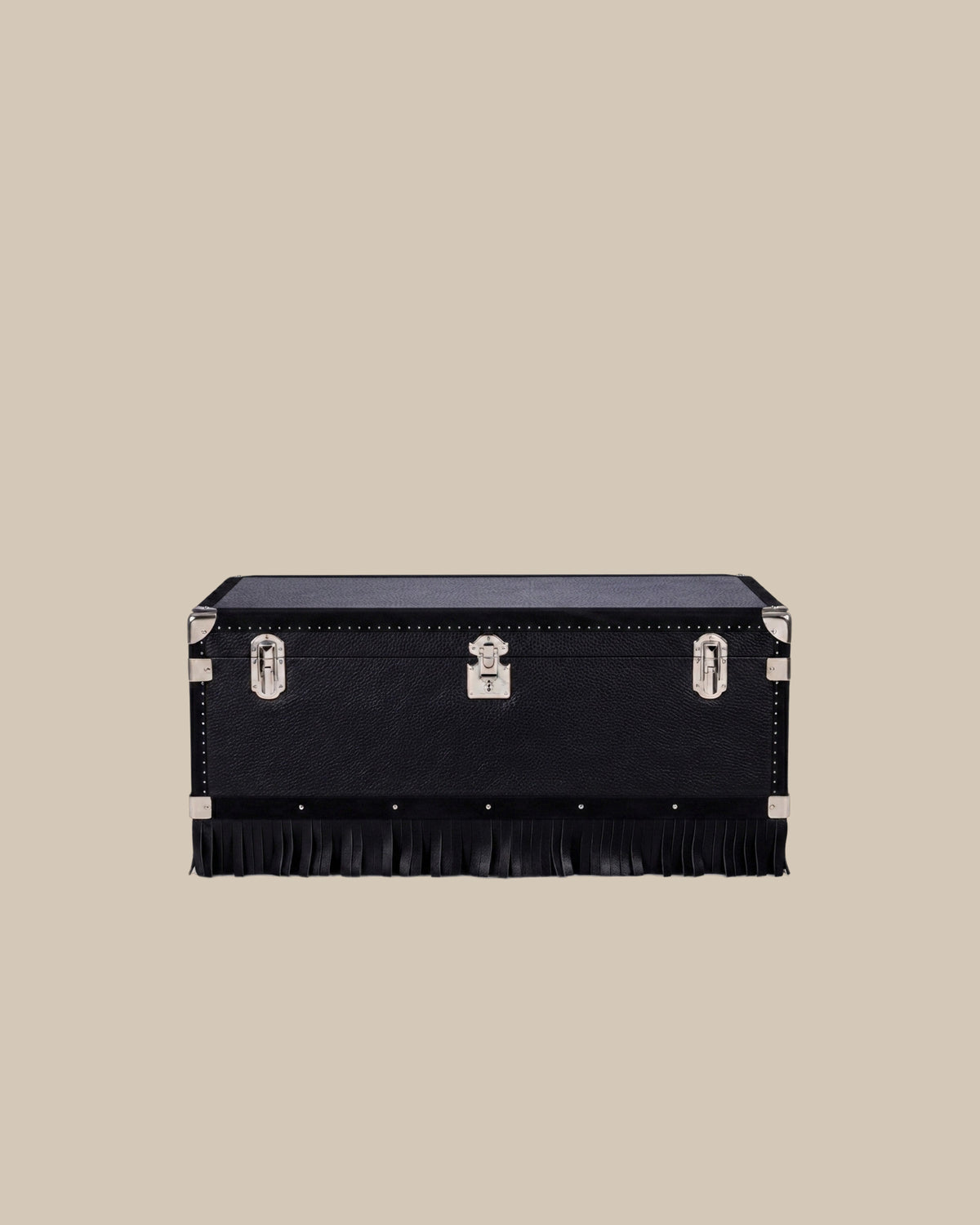 Black full-grain leather table trunk with leather fringe on a warm beige ground - Oberndörfer Milano