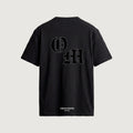 The Initials T-Shirt in black, back, interlocking O and M outlined in blackletter