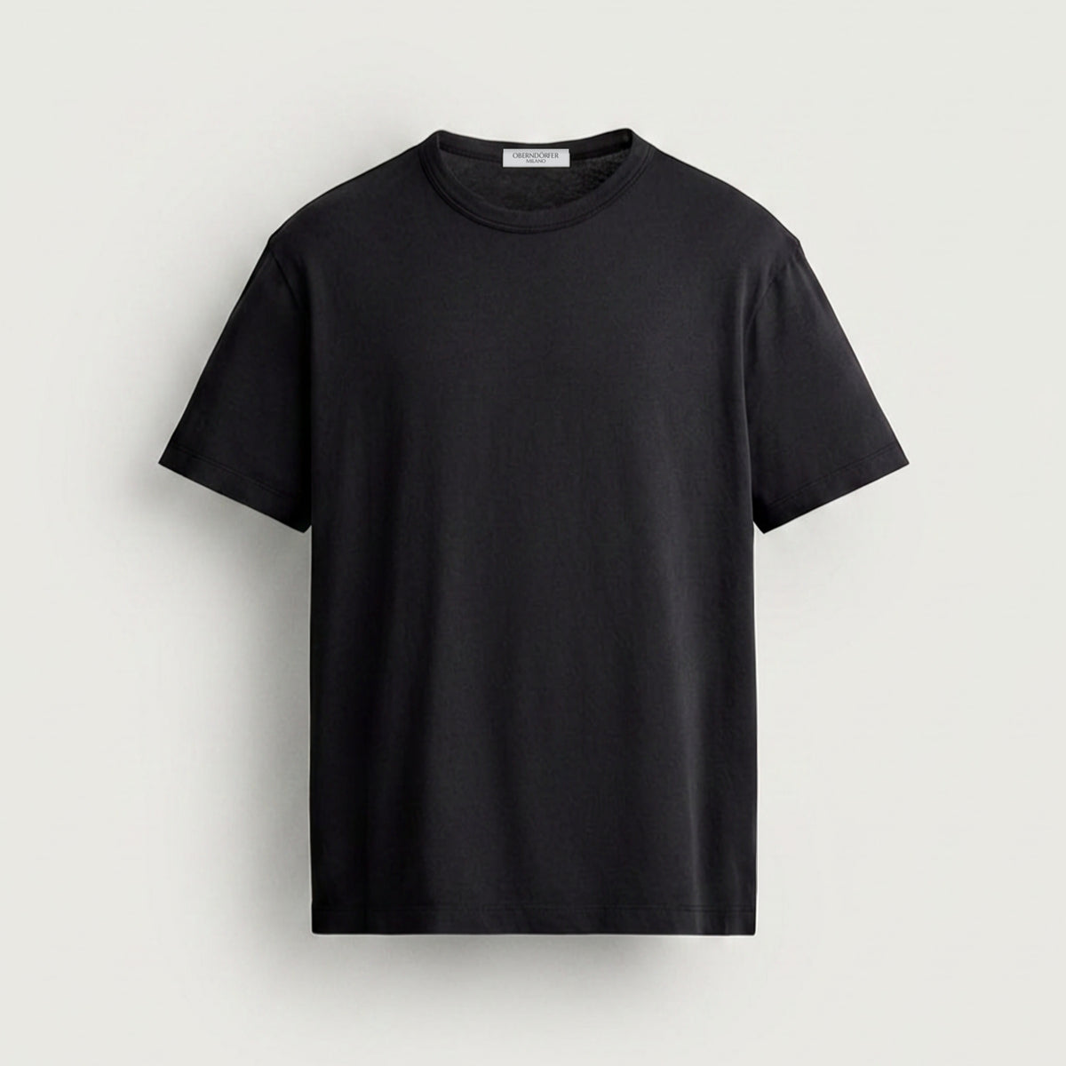 T-Shirt OM in black, front, small lockup at the chest